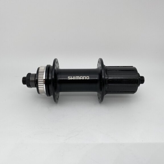 Rear hub / 135 MM / Drop axle / Disc (Centerlock) / 32GTS / Shimano / FH-TX505 Tourney / HG Body 35 MM  / Black / MTB - Tour 